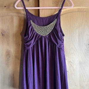 Purple tank with gold ornate on chest and braided straps.